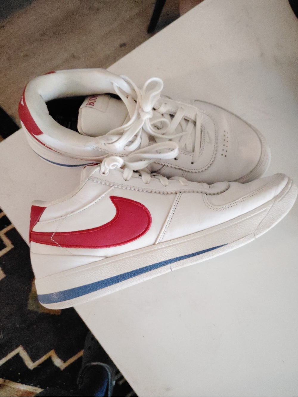 Nike Kids White Sneakers with Red Swoosh and Blue Stripe